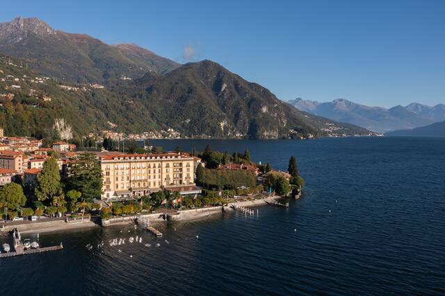 Aerial View of Grand Hotel Victoria by the Water with View of Mountains in Background