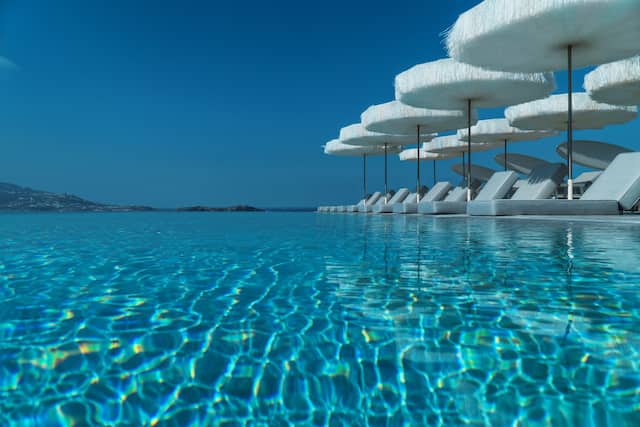 Infinity pool with loungers and parasols